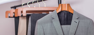 Gray suit jacket on a hanger with a blurred background