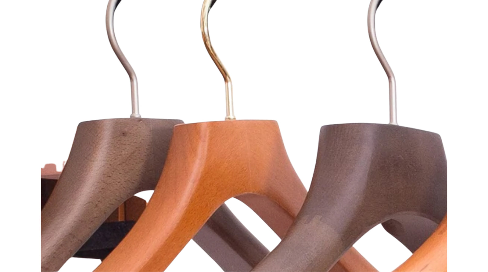 Set of wooden hangers in various colors on a white background